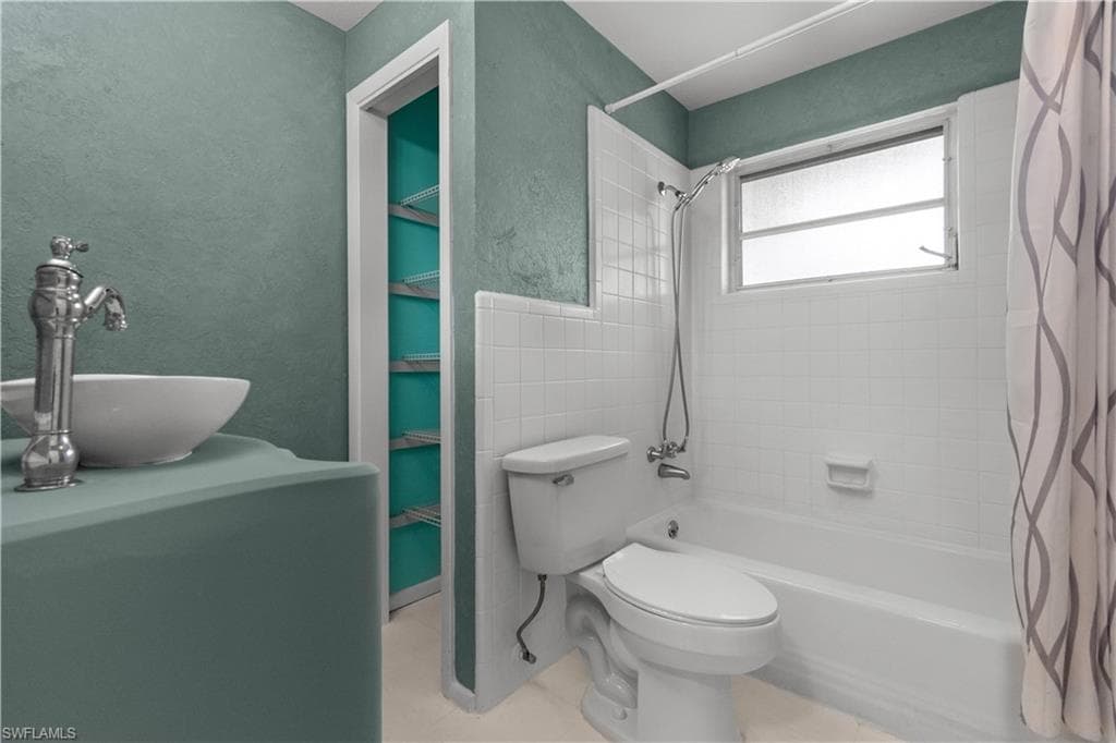 Guest bathroom featuring a tub/shower combo