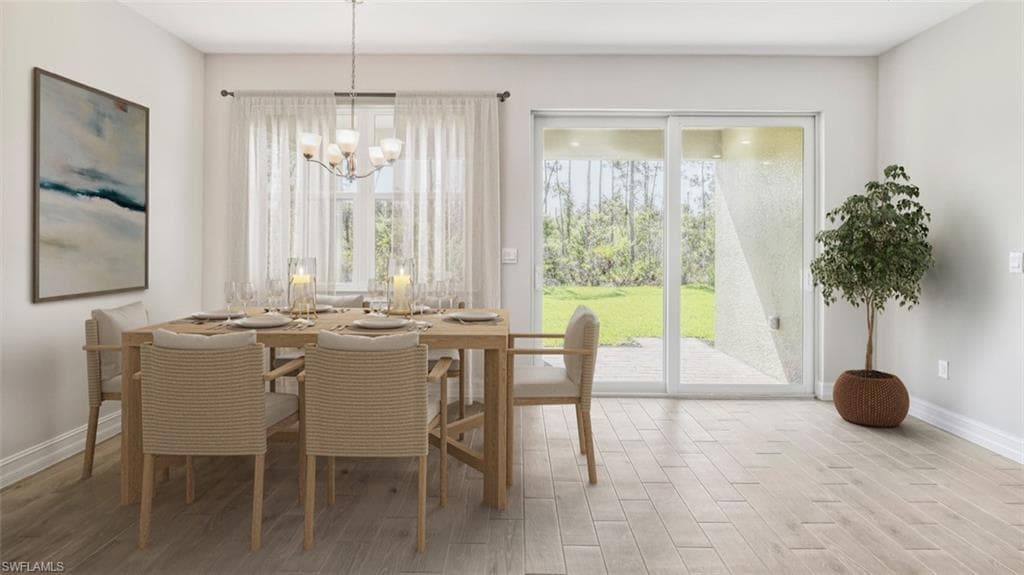 This image is virtually staged. Dining room with light wood-type flooring and a chandelier