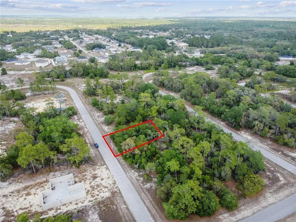 Wooded lot with established roadways and nearby residences