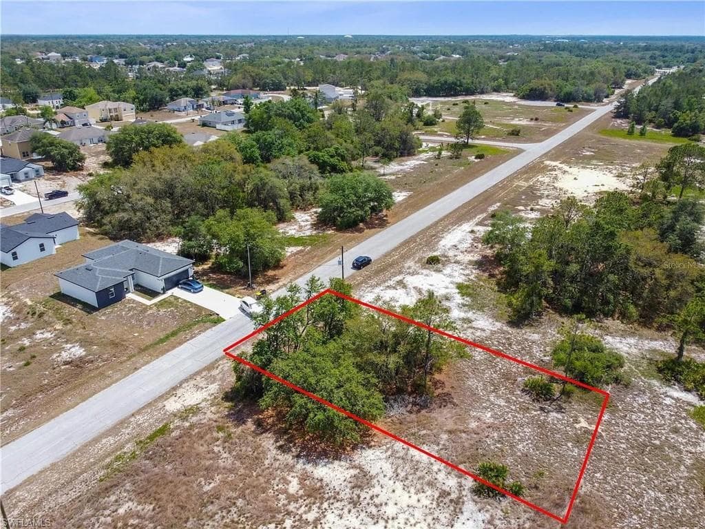 Expansive land parcel featuring mature trees and a clear, level terrain