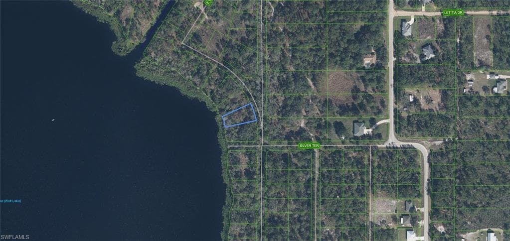Aerial Map. Displaying the geographic layout of the property in relation to surrounding parcels and a body of water