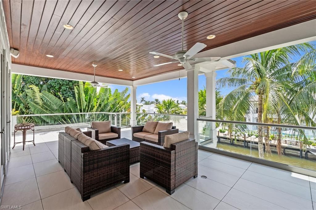 Covered outdoor patio with wood-panel ceiling and recessed lighting
