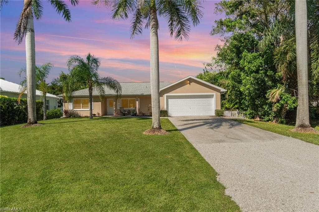 Single-story residence featuring a two-car garage, concrete driveway, and stucco exterior