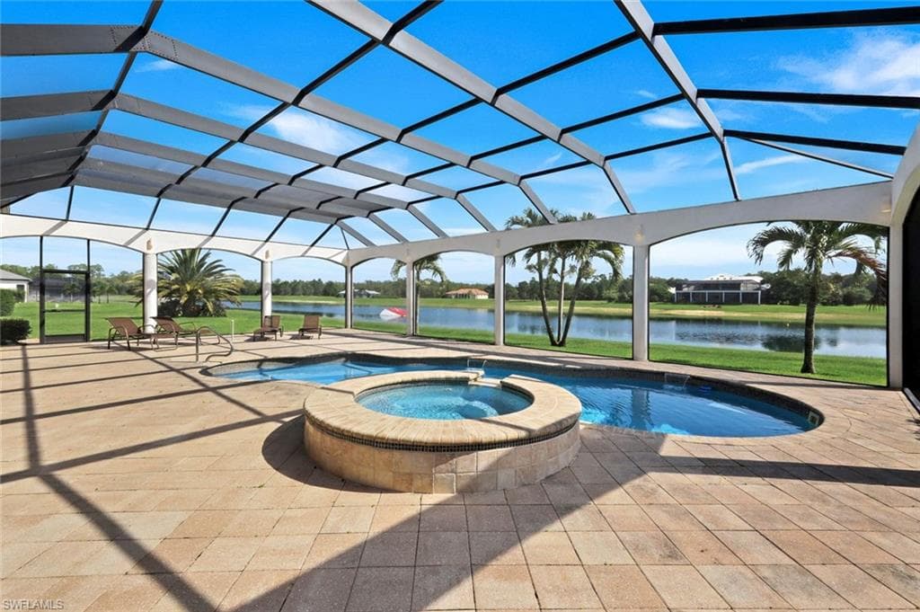 Screened pool enclosure with a custom-shaped swimming pool and integrated spa