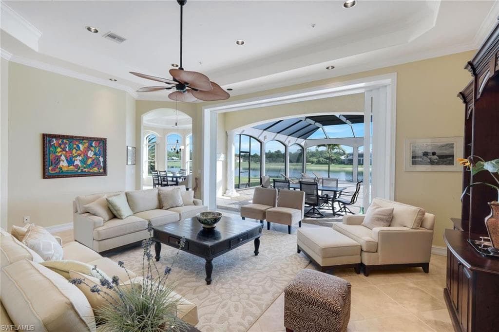 Recessed lighting, ceiling fan, crown molding, arched doorways, and tile flooring