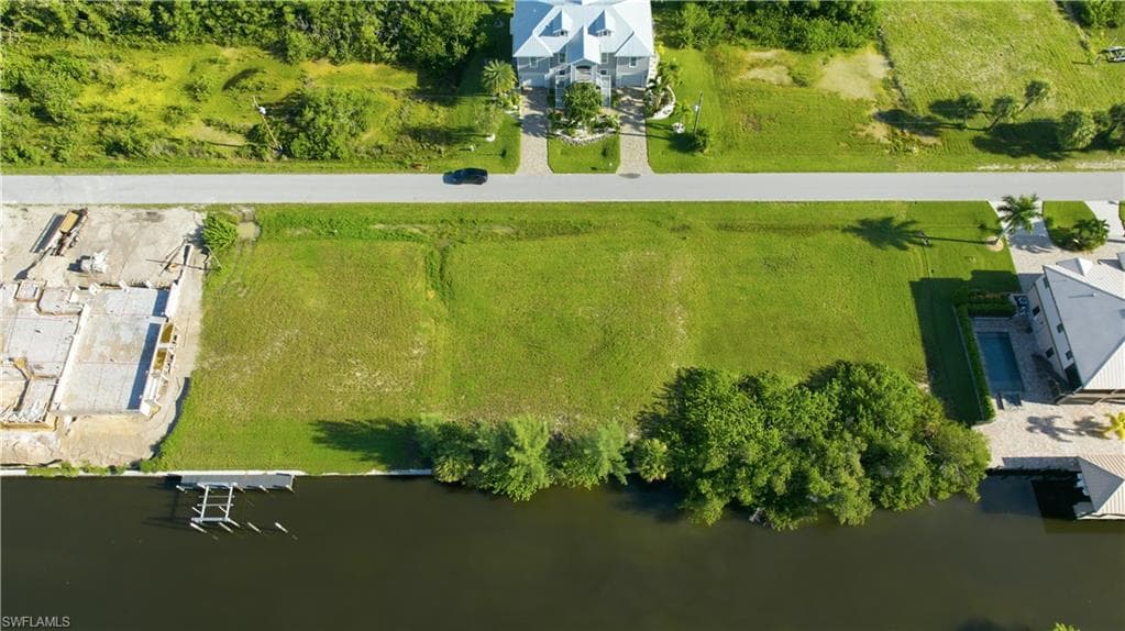 Expansive waterfront lot with mature trees and direct water access