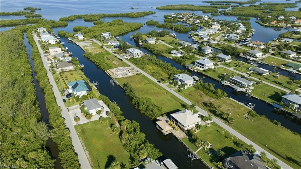 Waterfront community with direct canal access, surrounded by lush tropical foliage and open water