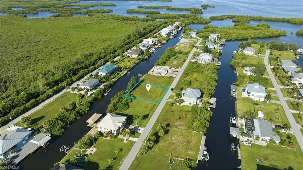 Waterfront lot with direct canal access, surrounded by established residential properties