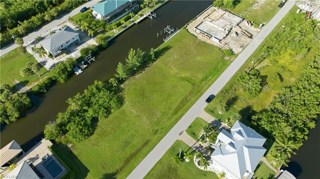 Expansive grassy lot with direct canal access