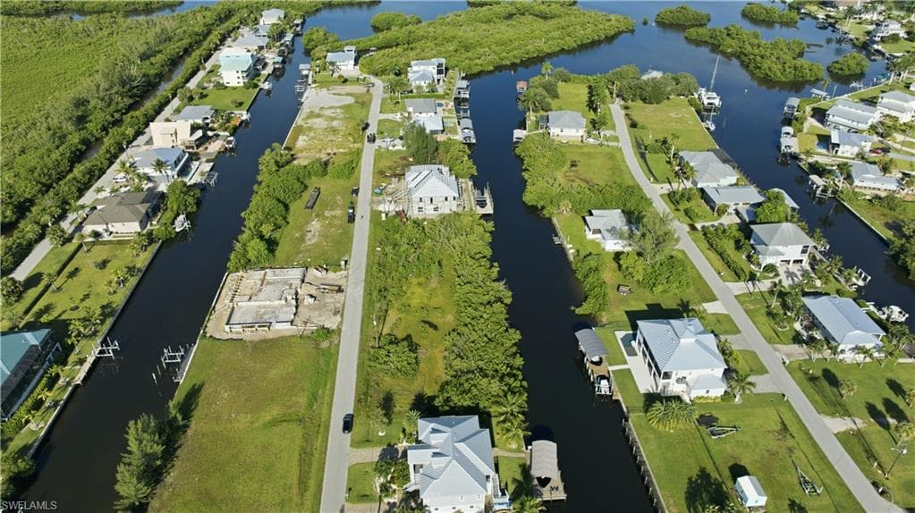 Waterfront community featuring canal access, residential properties, and natural vegetation