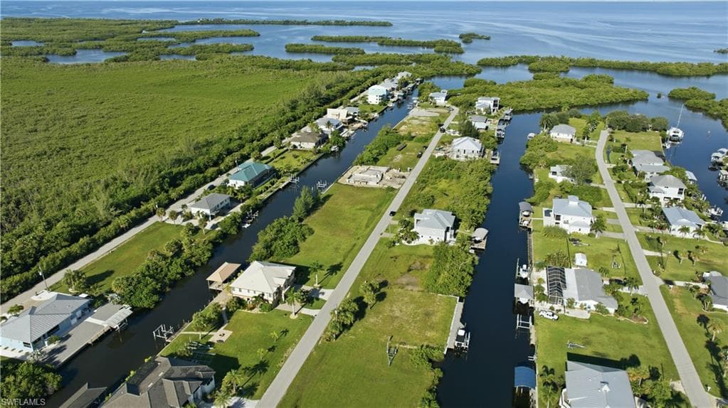 Waterfront properties with direct canal access, surrounded by lush green landscapes and open water