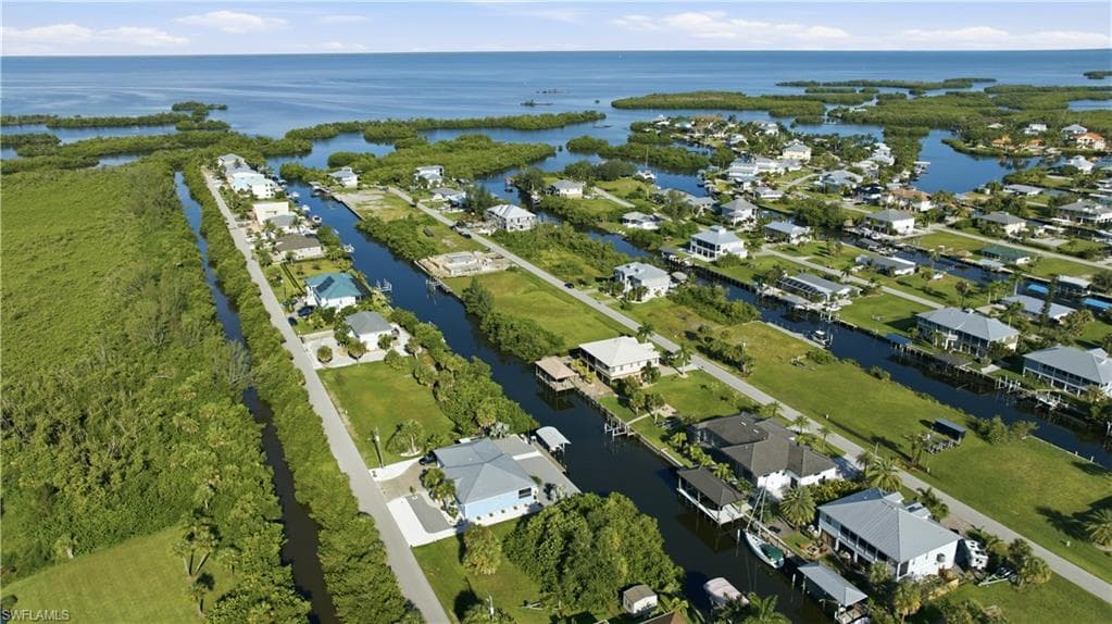 Waterfront community with direct Gulf access, residential canal access, and lush green landscaping