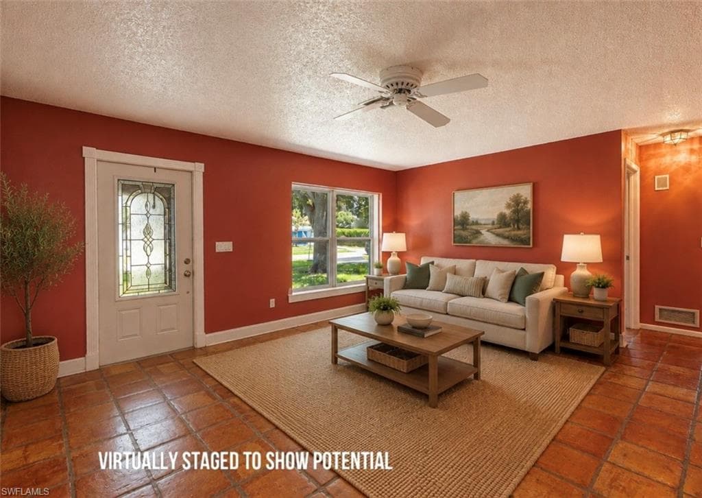VIRTUALLY STAGED Entryway featuring a decorative glass door, square tile flooring, and a ceiling fan