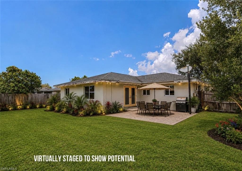 VIRTUALLY STAGED LANDSCAPING Expansive green lawn, paver patio, established landscaping, privacy fencing, and exterior lighting