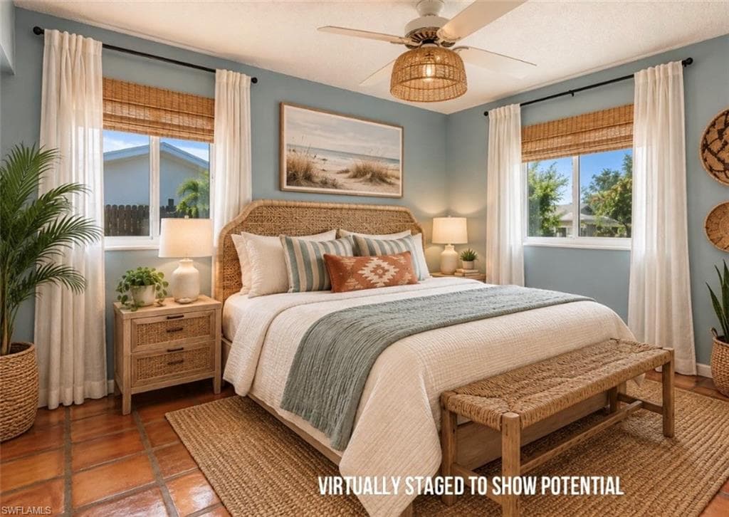 VIRTUALLY STAGED Terracotta tile flooring, dual windows with bamboo shades and curtain rods, and a ceiling fan with integrated lighting