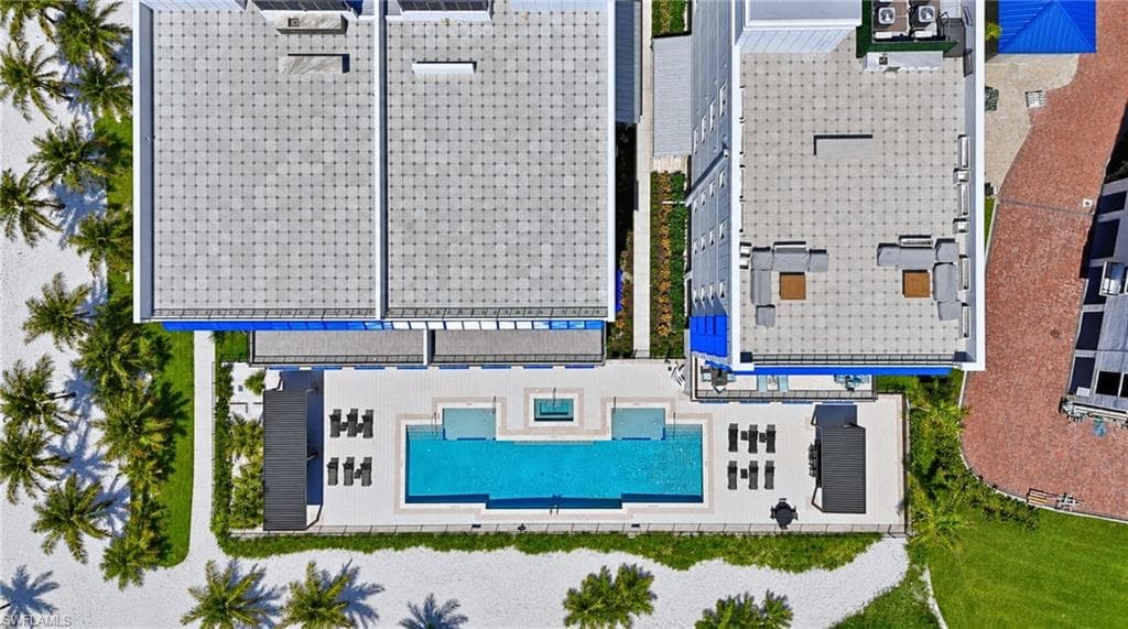 Rooftop amenities featuring a pool, spa, and lounge seating areas - Virtually Edited Image