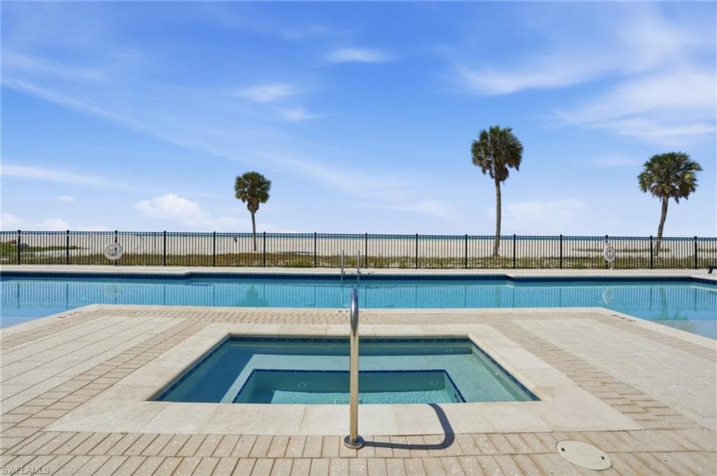 Community pool with a hot tub and a patio
