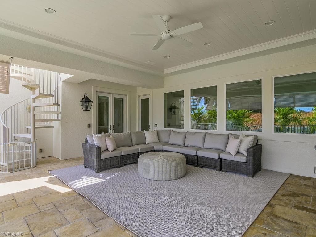 Great covered outdoor space with stairway to rooftop deck.