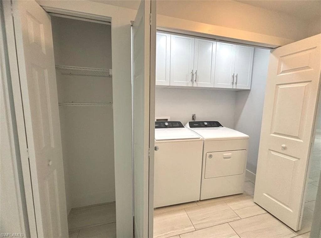Laundry area with cabinet space and separate washer and dryer