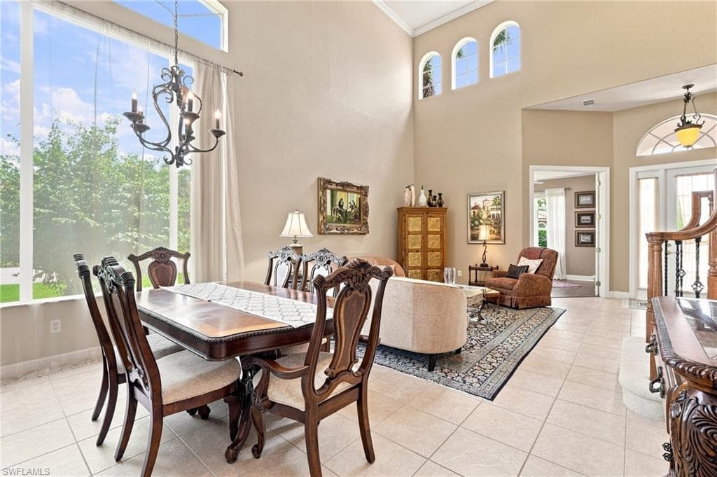 Two-story living area with high ceilings, large windows, and arched transom windows