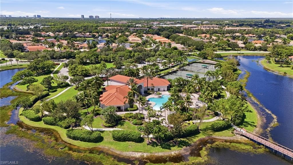 Community grounds featuring a swimming pool, tennis courts, and established landscaping