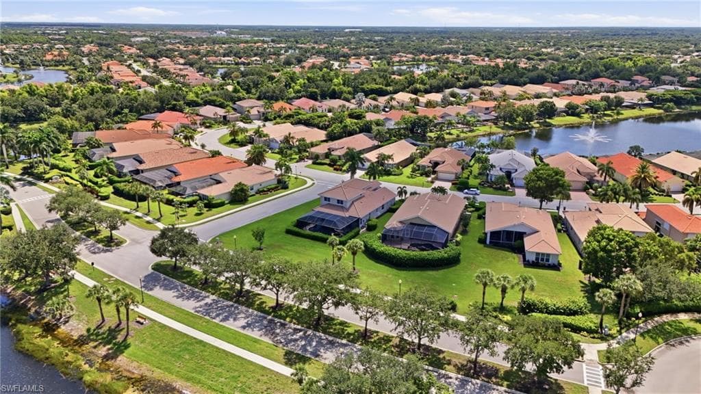 Residential community with mature landscaping, multiple water features, and varied architectural styles