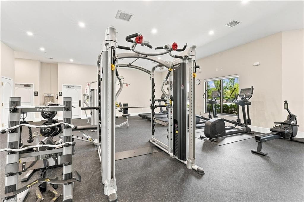 Fitness area featuring recessed lighting, a rubber-finish floor, and multiple windows