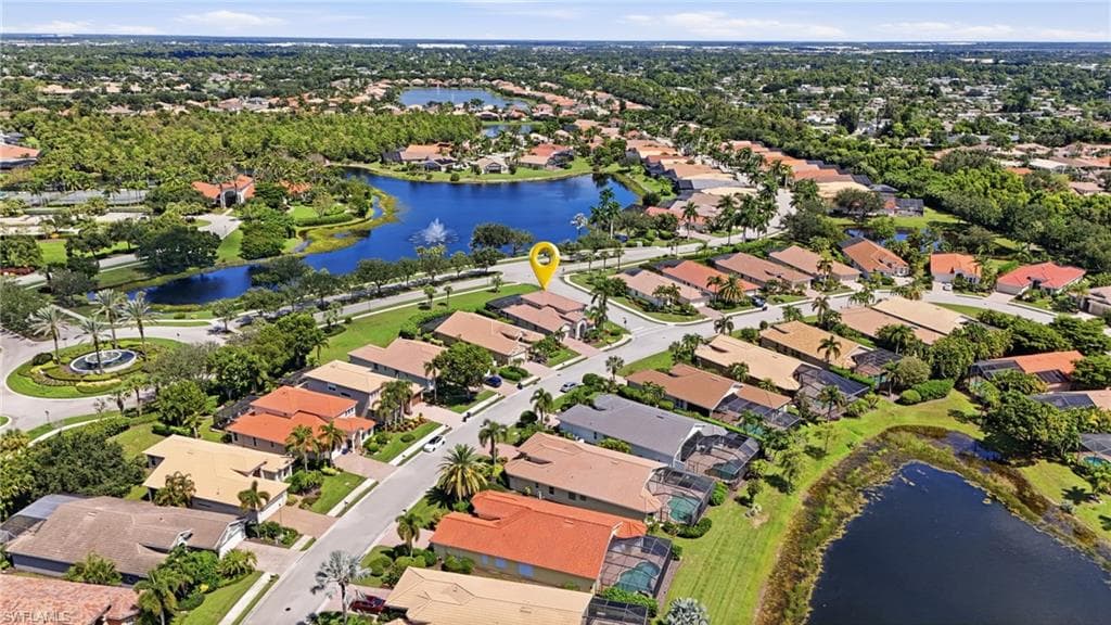 Residential community with multiple water features, abundant mature landscaping, and an organized street layout