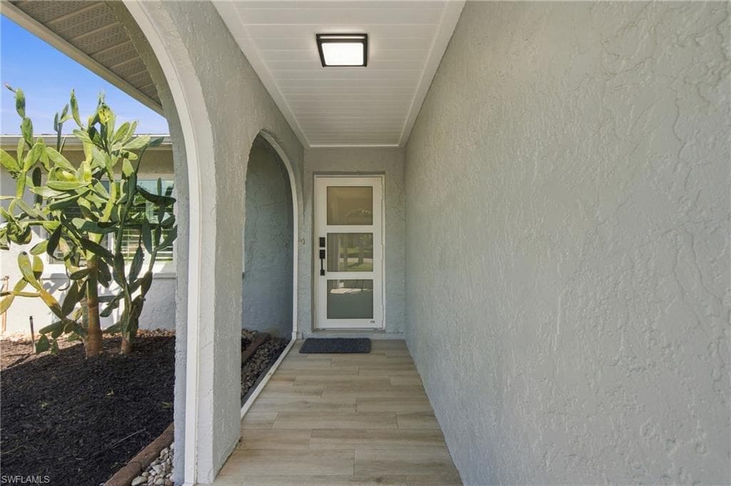 Tiled entry with new front door.