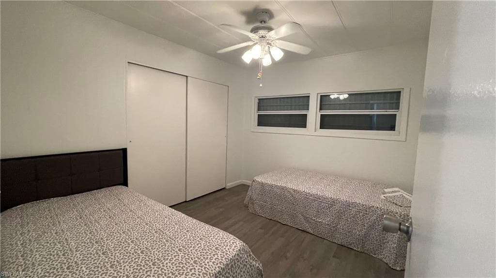 Bedroom featuring ceiling fan, vinyl flooring, and a closet