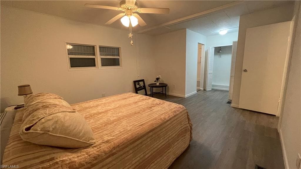 Bedroom with ceiling fan and vinyl flooring