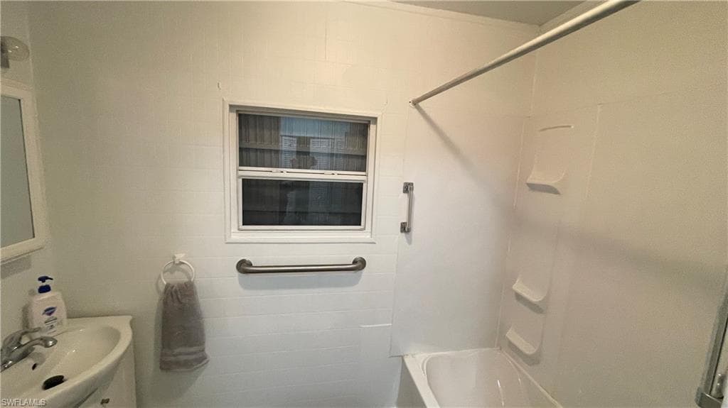 Bathroom featuring sink and shower / bath combination