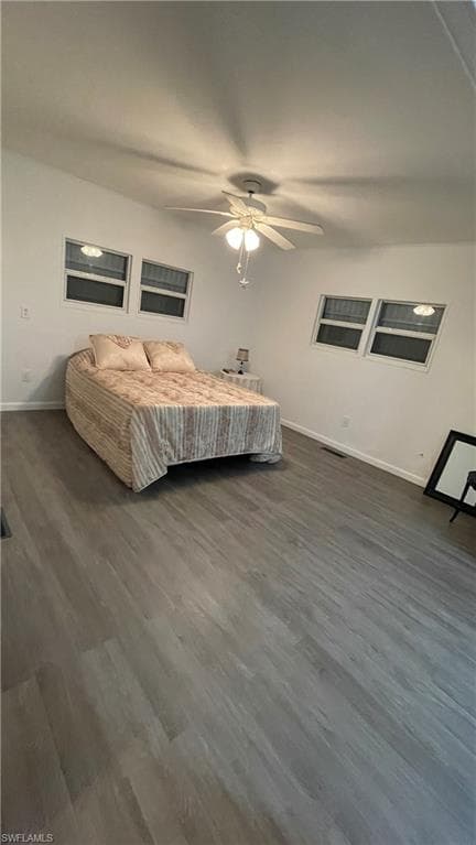 Bedroom with ceiling fan and vinyl floors