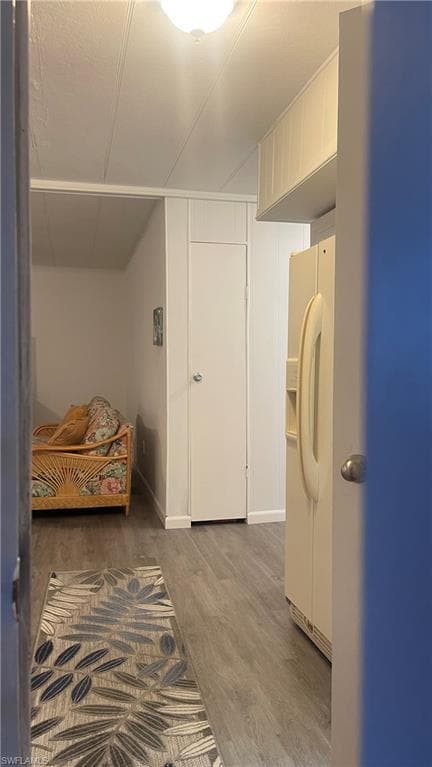 Carport side home entrance door with vinyl flooring and white fridge