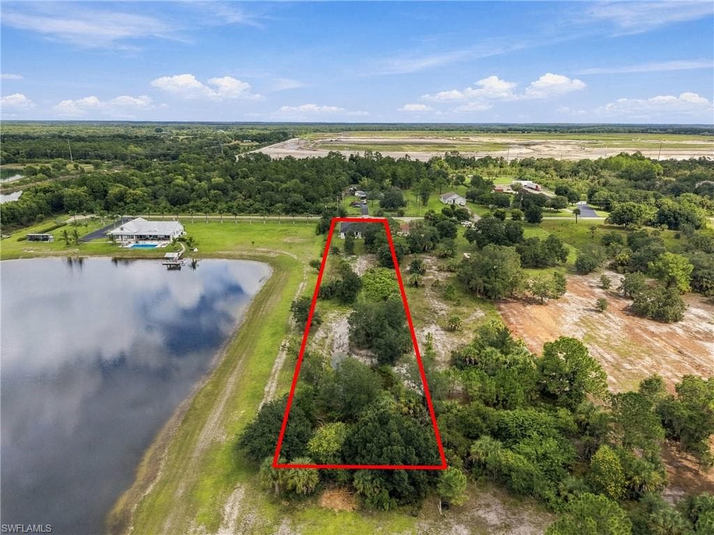 Expansive undeveloped lot featuring mature trees and a waterfront boundary