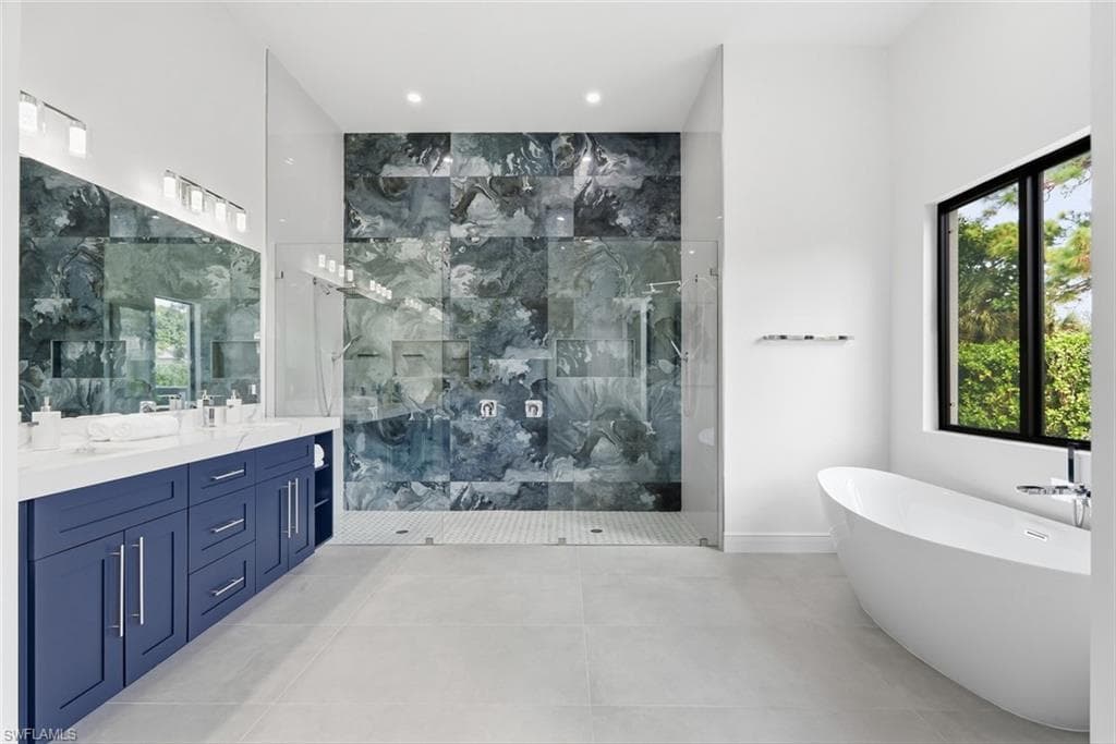 Dual vanity with deep blue cabinetry and white countertops