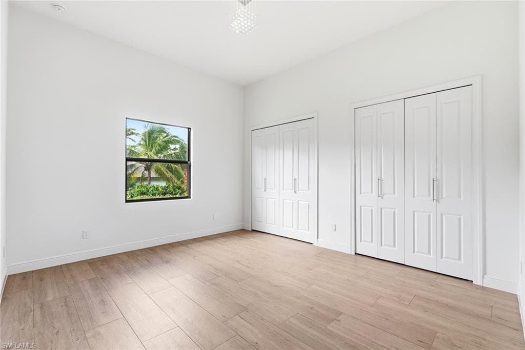 Recessed lighting, wood-finish flooring, and dual bi-fold closet doors